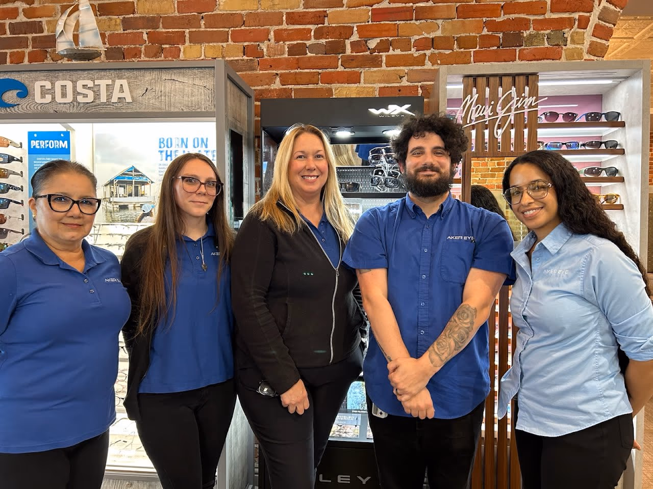 The optical team at Aker Eye Downtown, in front of the Costa, Wiley X and Maui Jim sunglass displays on the ground floor