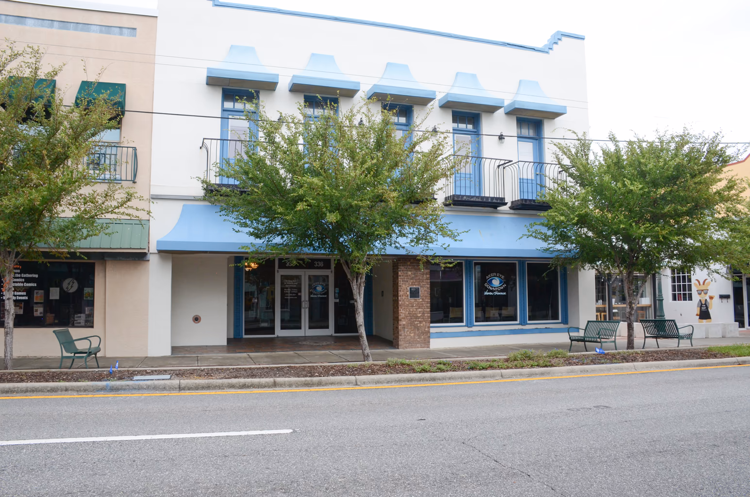 The Aker Eye Downtown entrance under the sky-blue awnings on S Washington Ave