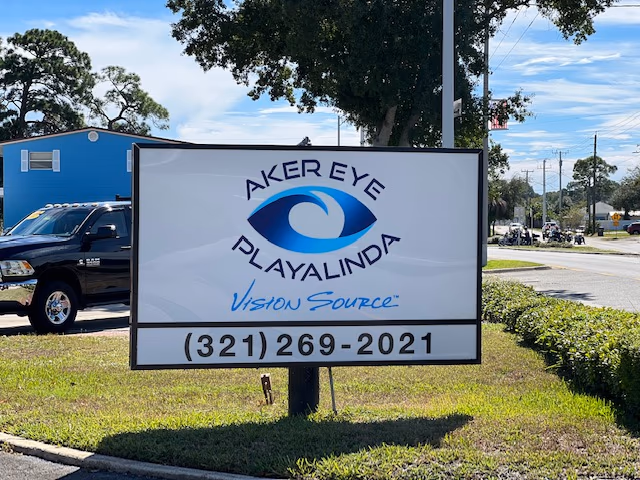 The Aker Eye Playalinda sign at the road on S Washington Ave, with the phone number