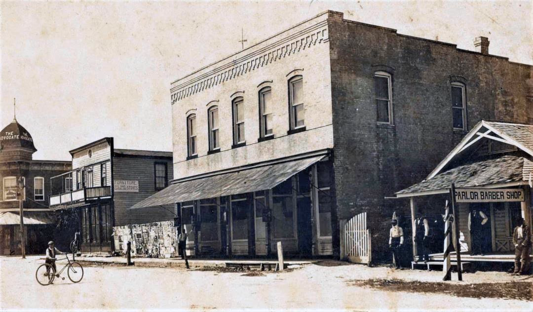 The Losley Saloon and Alpine Hotel building at 338 S Washington Ave, Titusville, in 1888, with the Parlor Barber Shop next door